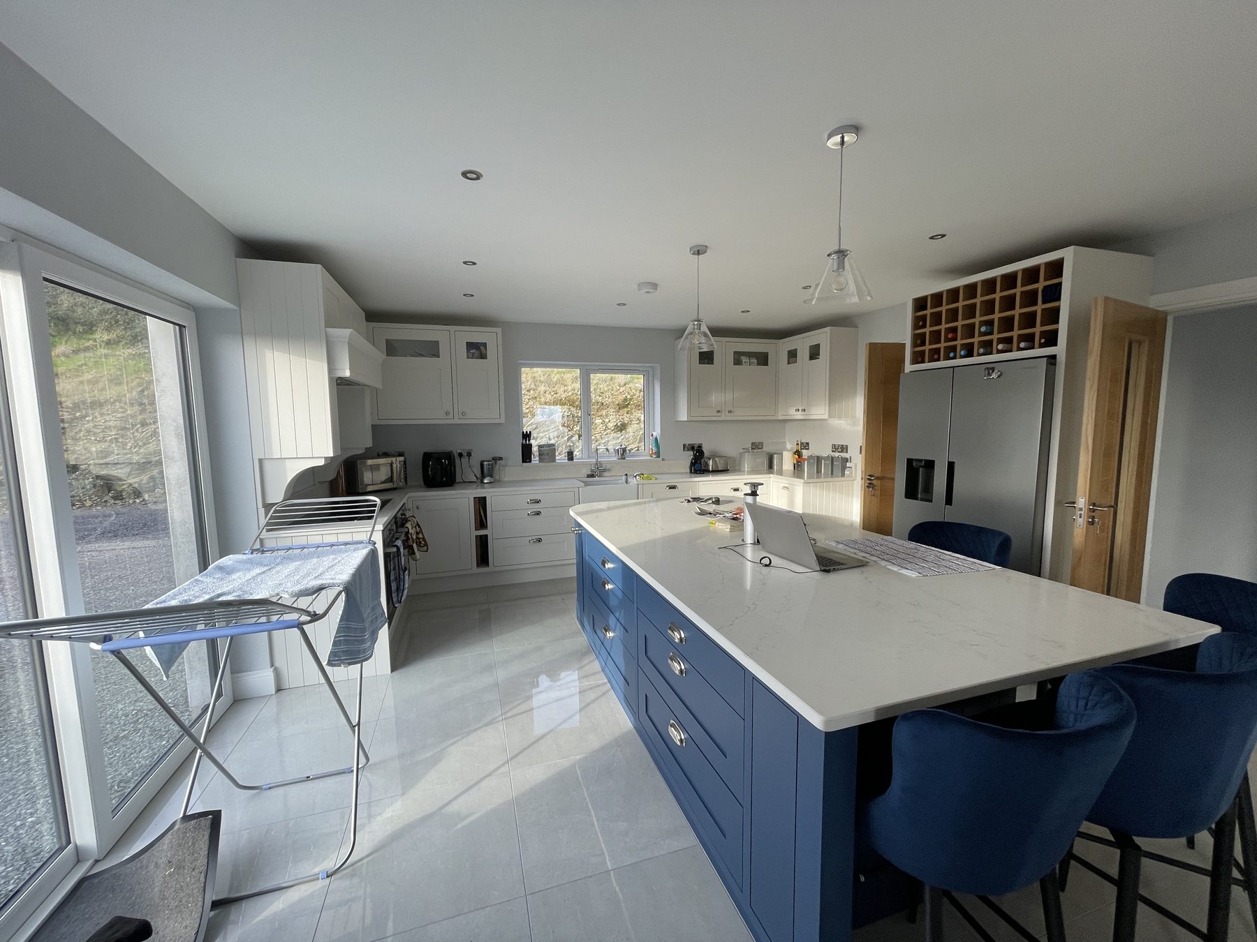 White shaker kitchen with a blue island (finished) - fitted by Kitchen Hero