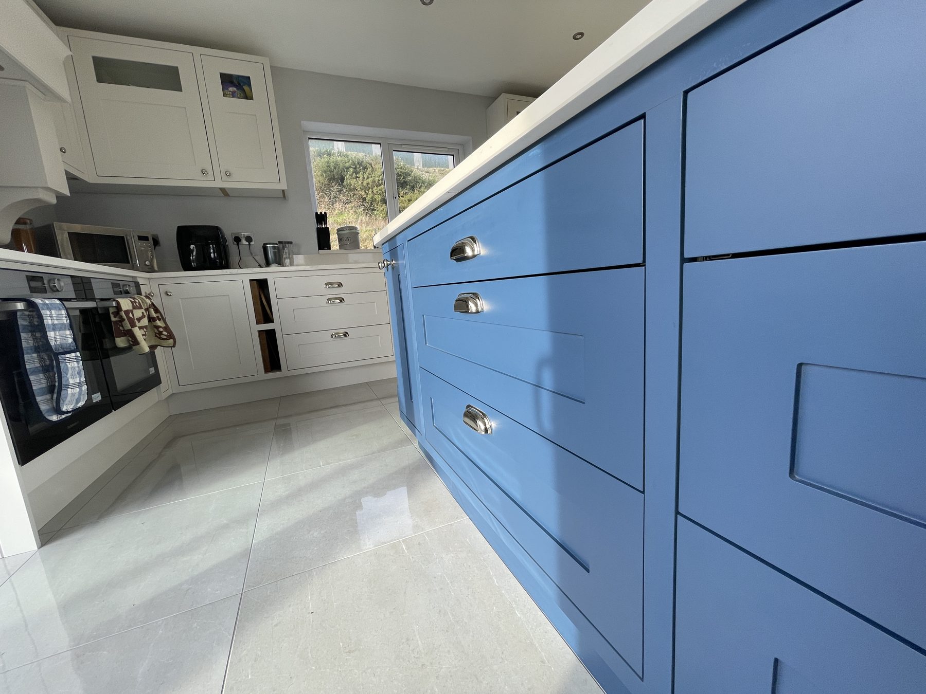 White shaker kitchen with a blue island (finished) - fitted by Kitchen Hero