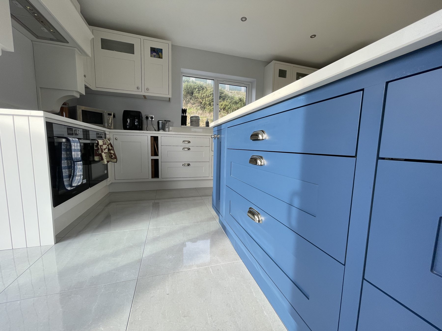 White shaker kitchen with a blue island (finished) - fitted by Kitchen Hero