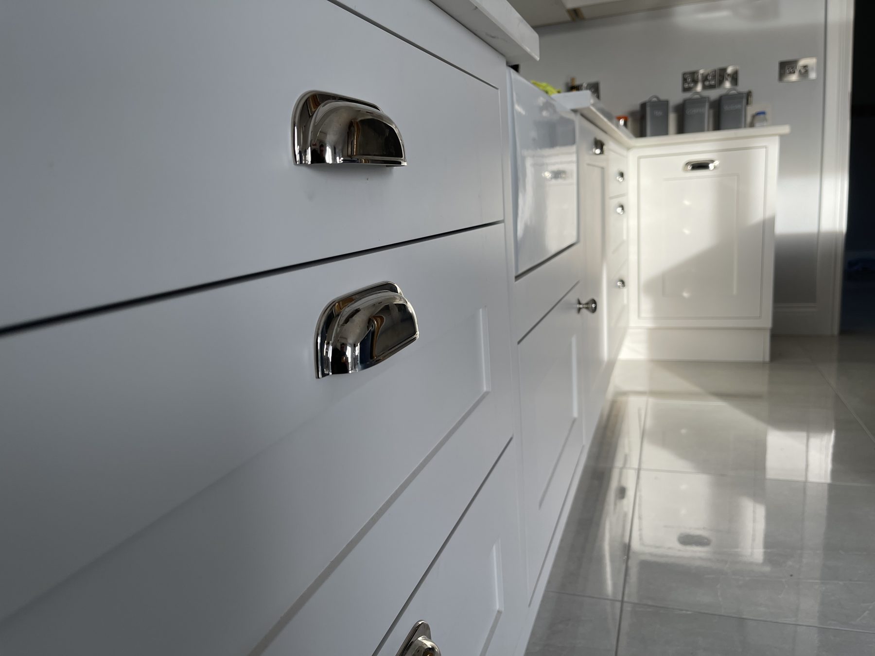Close-up of cup handles on painted drawer fronts
