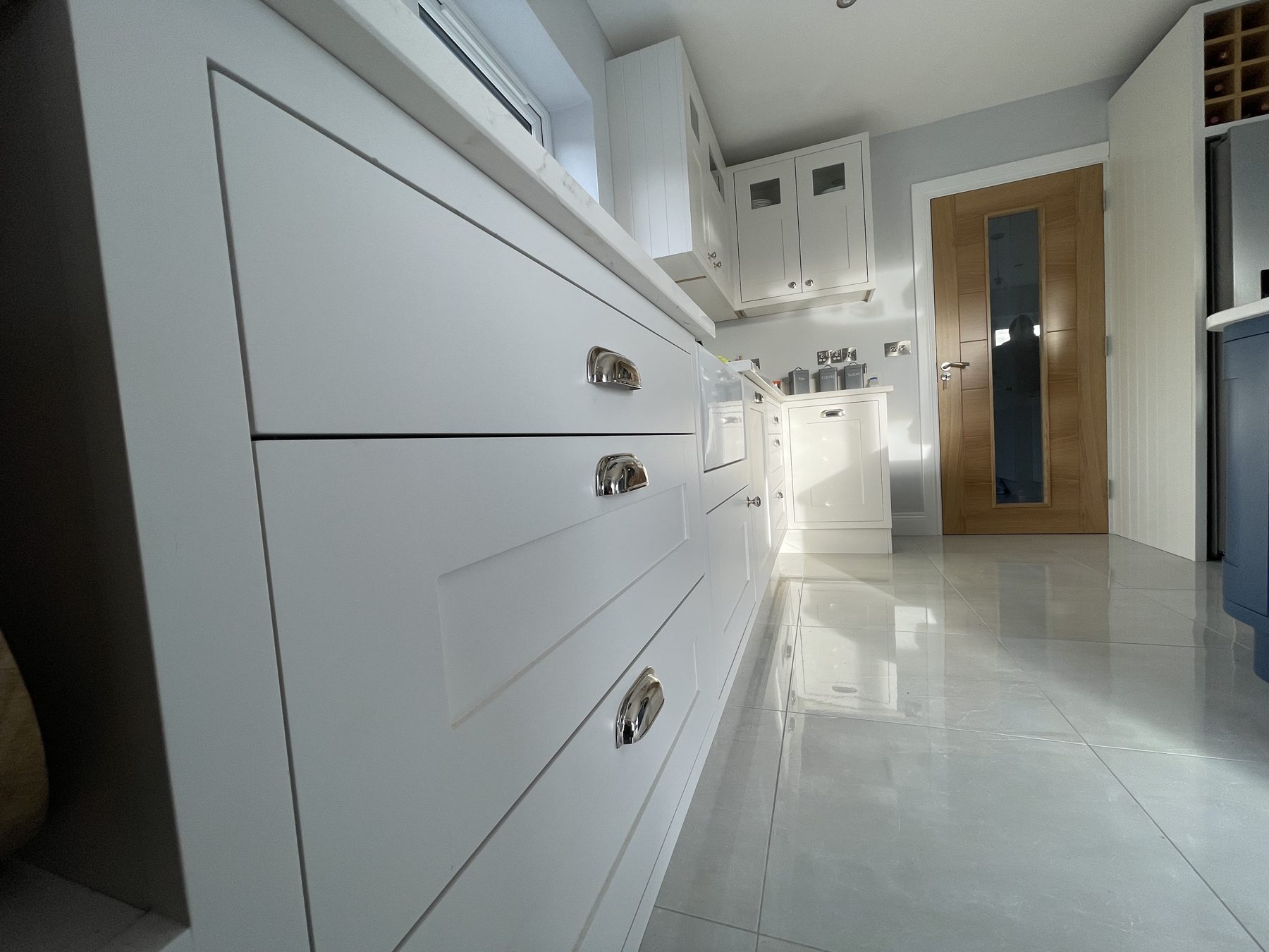 White shaker kitchen with a blue island (finished) - fitted by Kitchen Hero