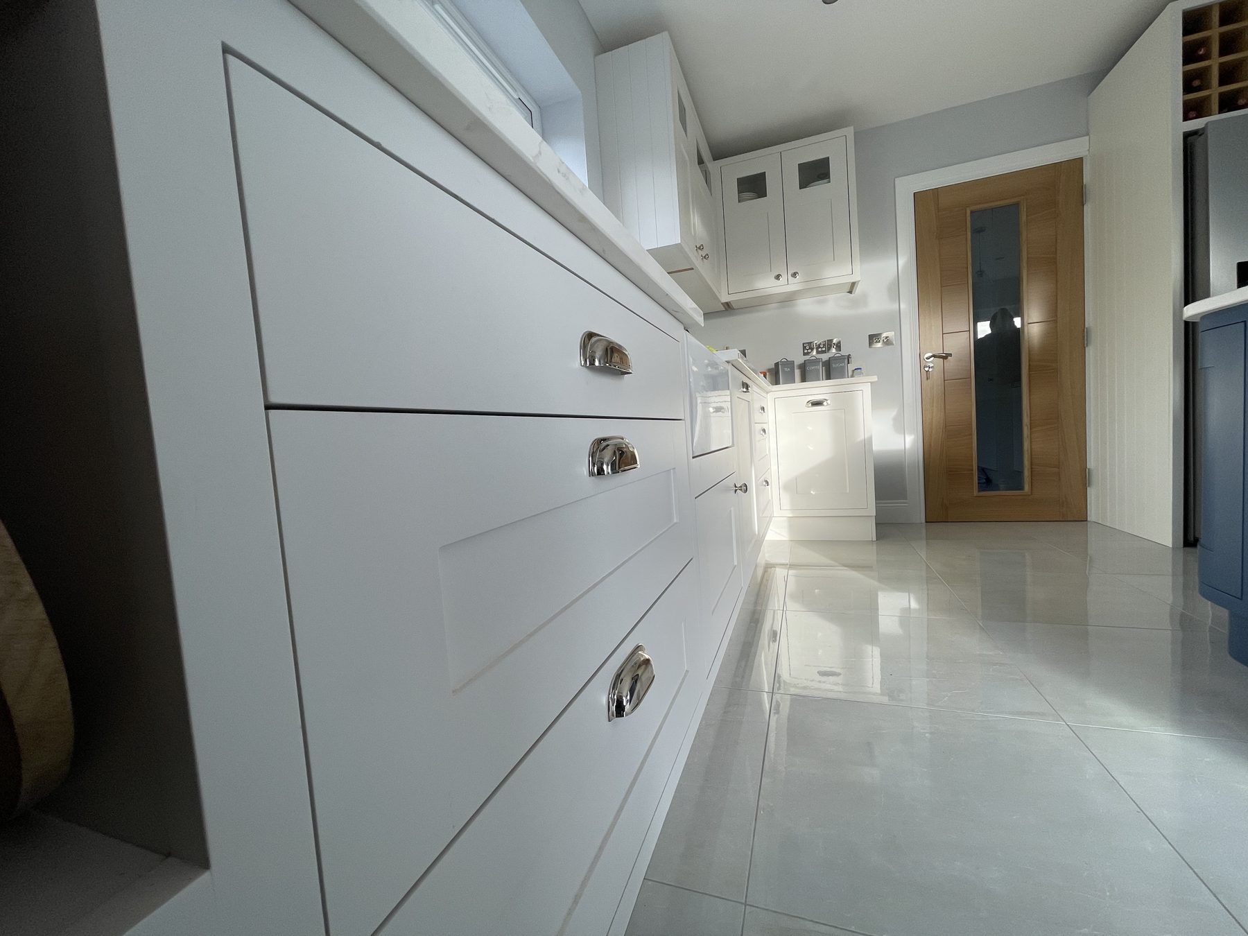White shaker kitchen with a blue island (finished) - fitted by Kitchen Hero