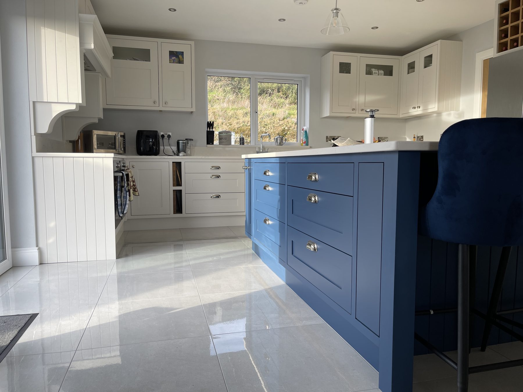 White shaker kitchen with a blue island (finished) - fitted by Kitchen Hero