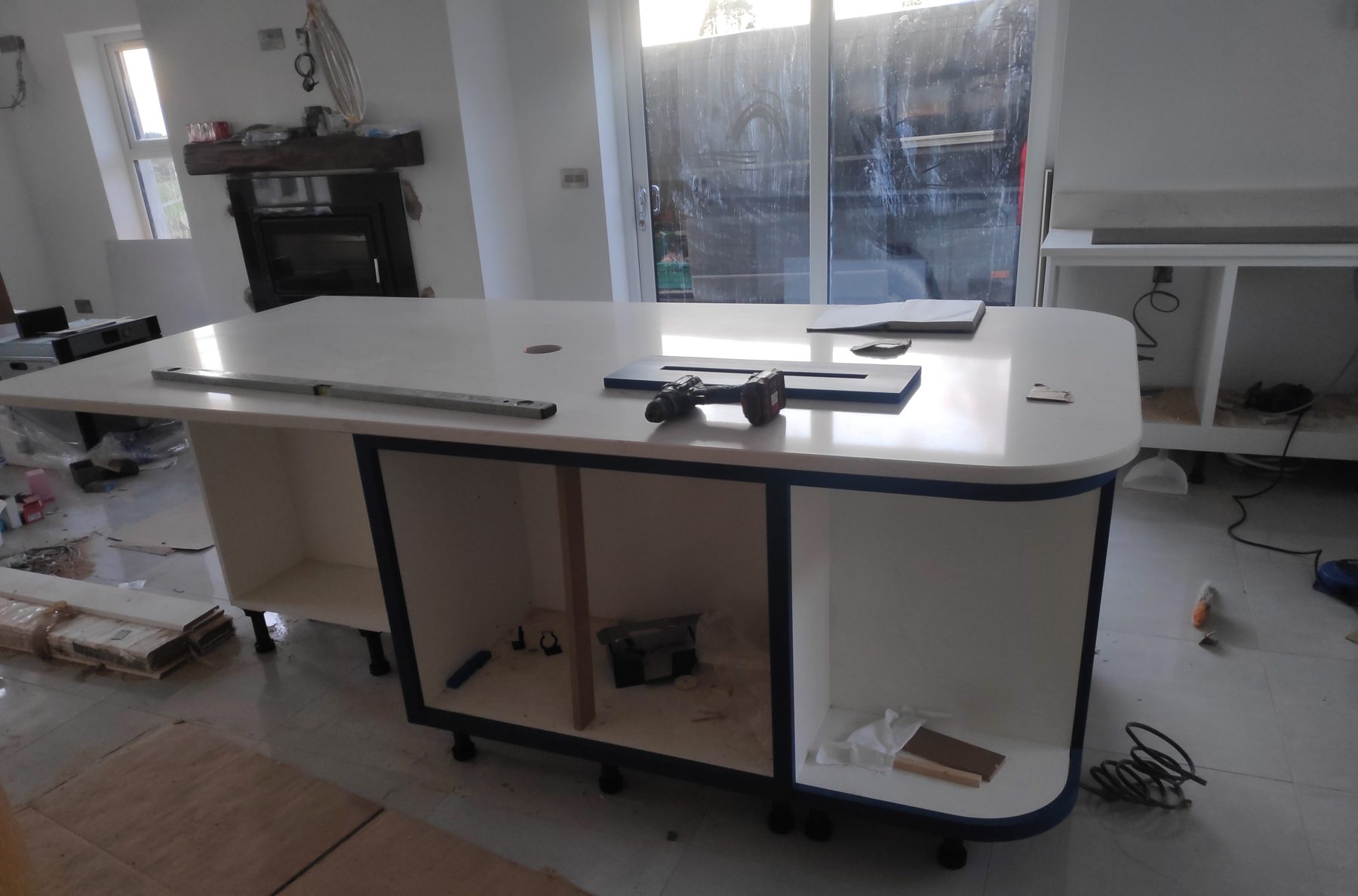 White shaker kitchen with a blue island (mid-fit) - fitted by Kitchen Hero