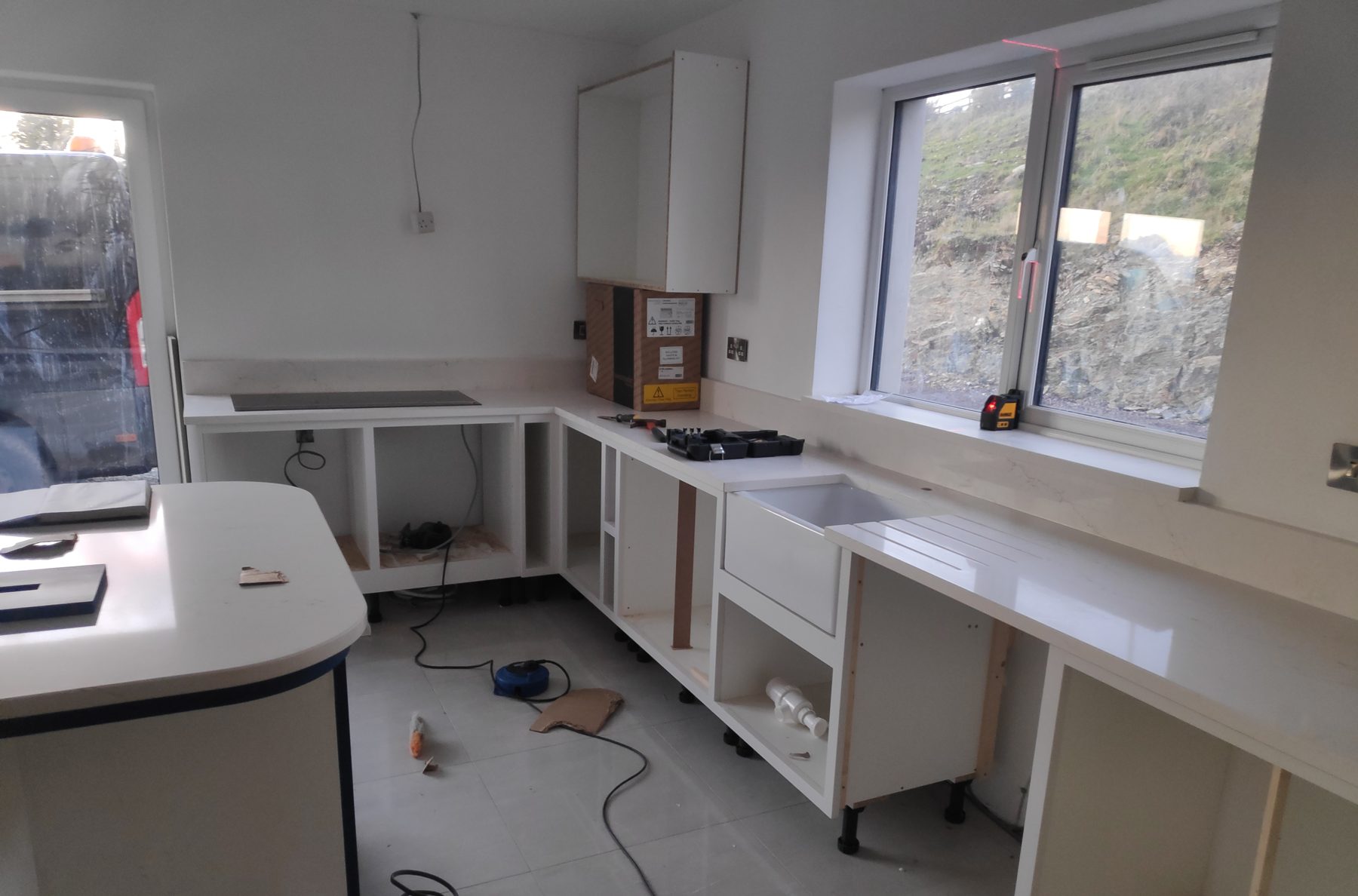 White shaker kitchen with a blue island (mid-fit) - fitted by Kitchen Hero