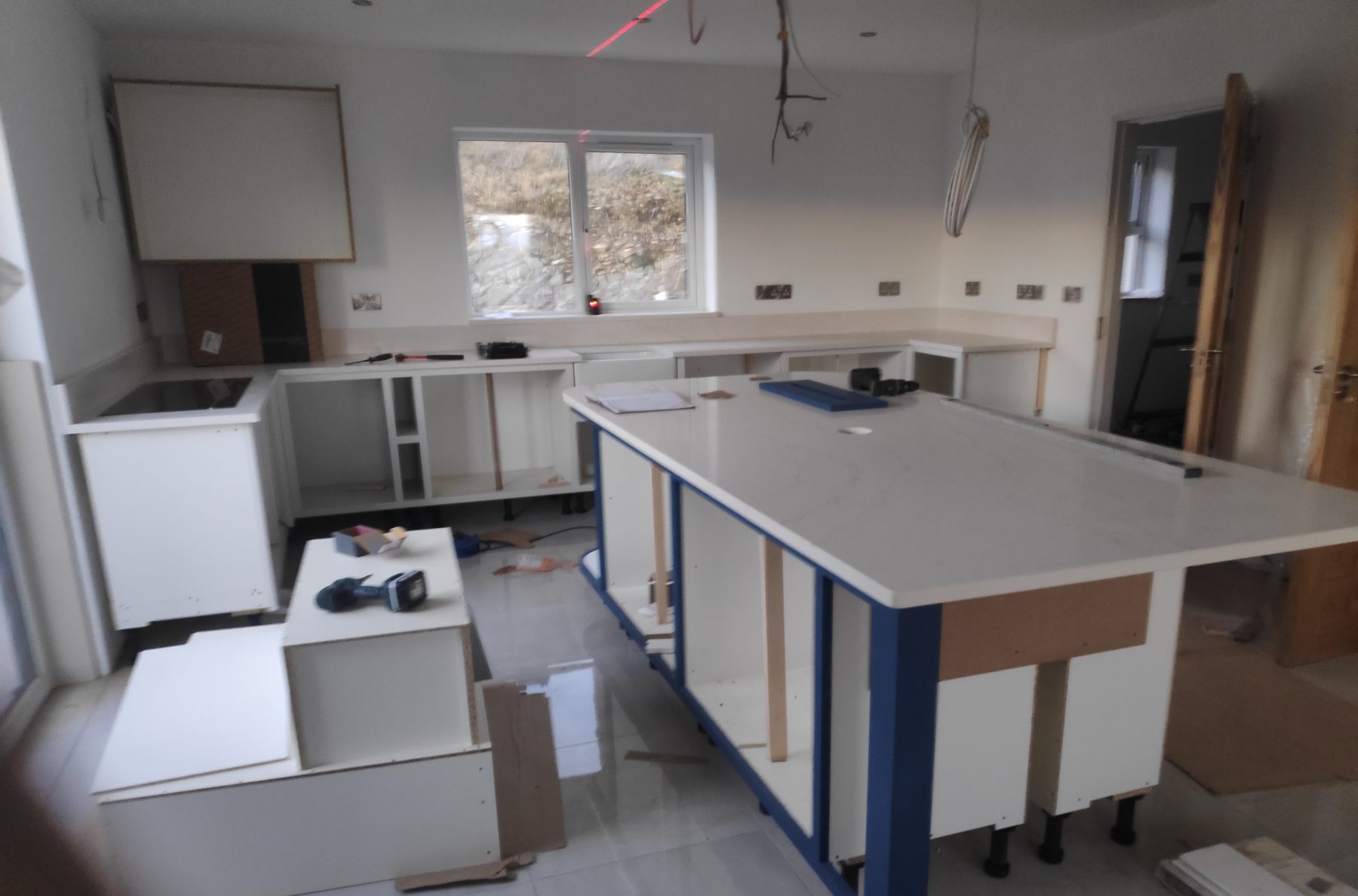 White shaker kitchen with a blue island (mid-fit) - fitted by Kitchen Hero