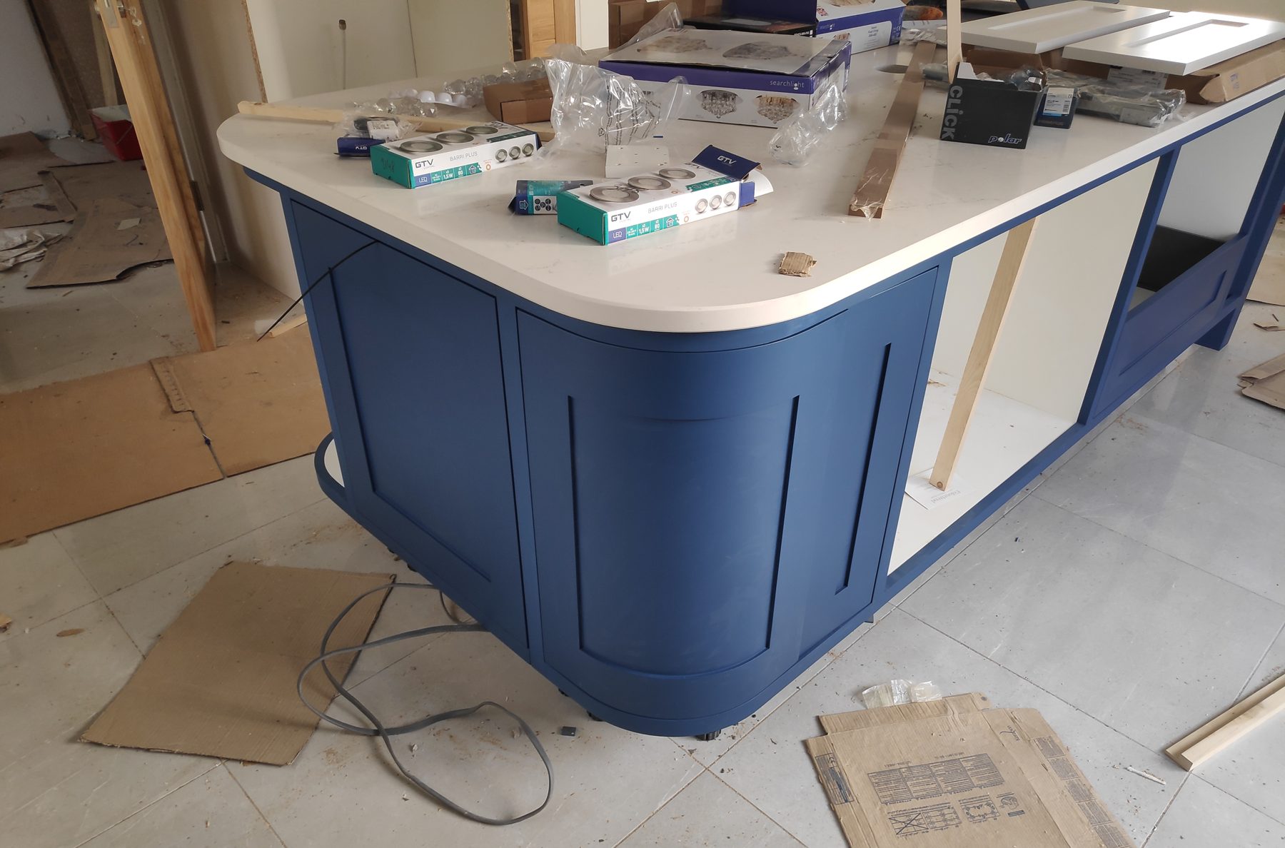 White shaker kitchen with a blue island (mid-fit) - fitted by Kitchen Hero