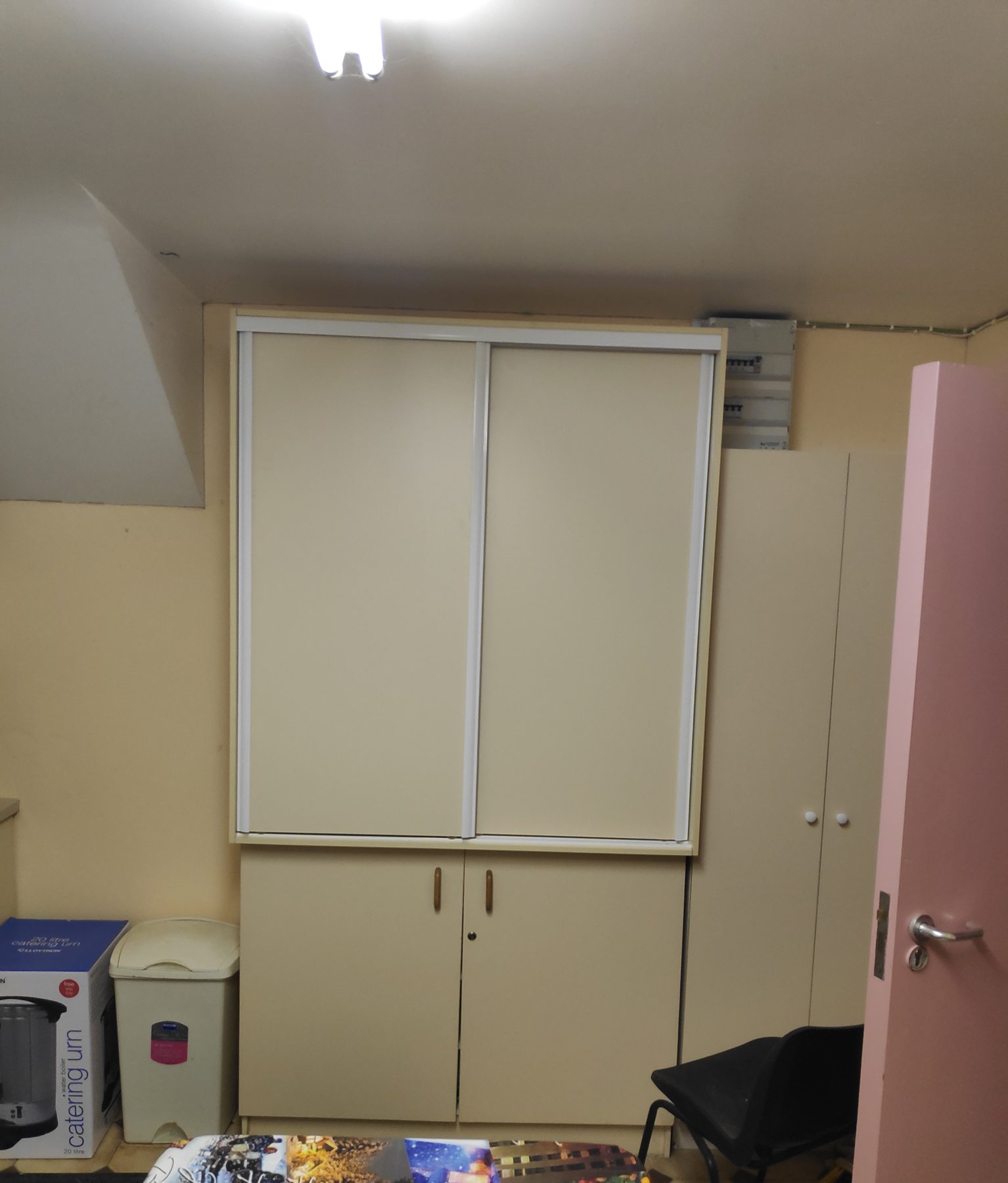 Cream sliding wardrobe over cupboards (finished) - fitted by Kitchen Hero